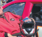 Image of JR next to race car