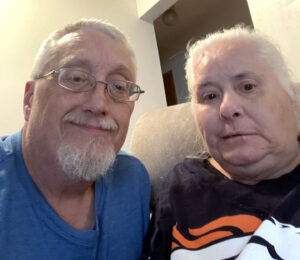 Man and woman posing for photo