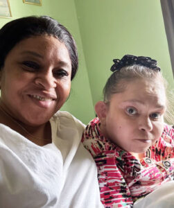 Two women posing and smiling for photo