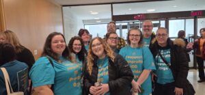 Several Oregon team members in the hall of the state Capitol.