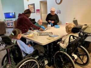 People gathered around a kitchen table.