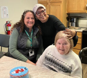 Three people posing for photo.