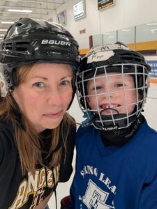 Jennifer McAlpine with her older son on the honkey rink.
