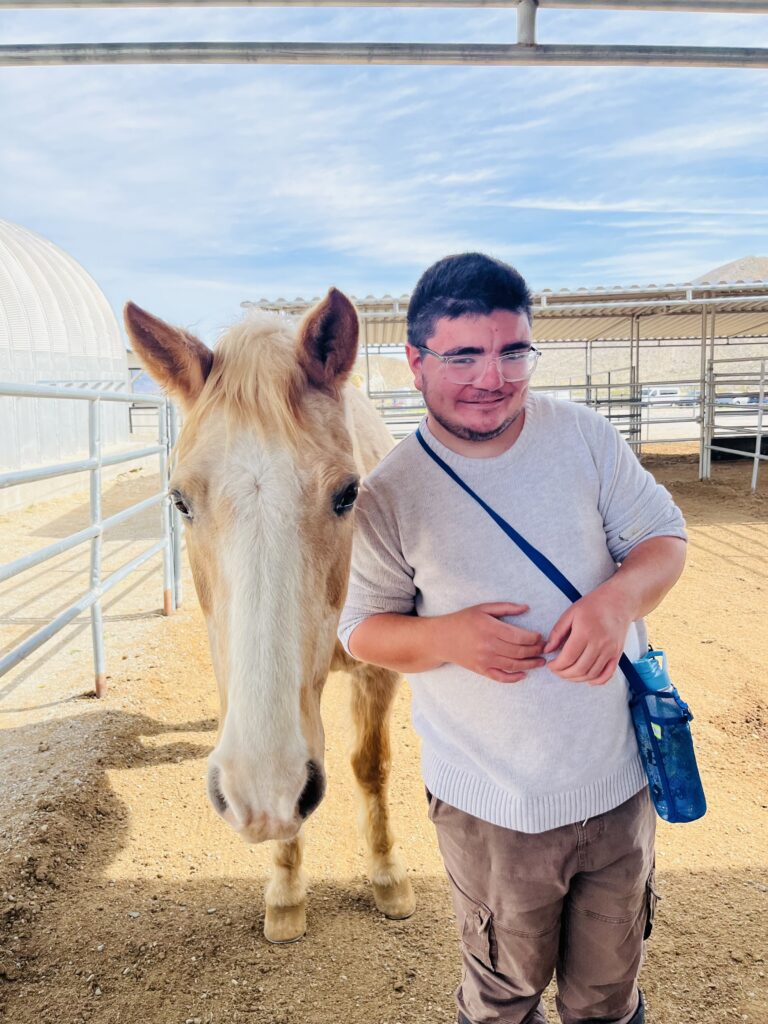 Nelson with a horse on a farm.