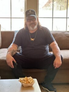 Jene Morris sitting on a couch.