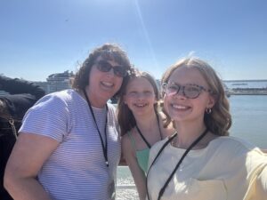 Monica Baty with two daughters outside.