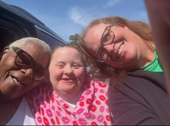 Close-up of three women smiling.