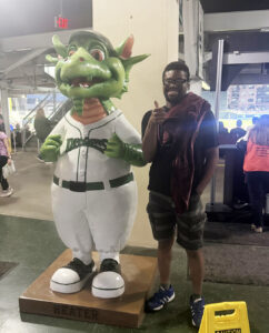 Quan standing next to a Dayton Dragon baseball statue.