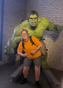 Bailee Heer posing in front of a Hulk statue.