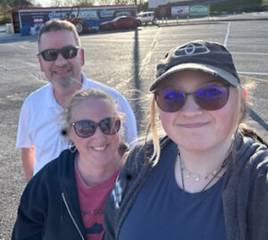 Lee-Ellen Bailey with her husband and daughter outside.