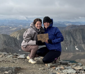 Kayla Rheingans and another woman posing in front of a mountain vista.