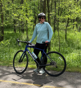 Kayla Rheingans standing with her bicycle.