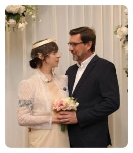Walt Courtney standing with a woman in a wedding dress.