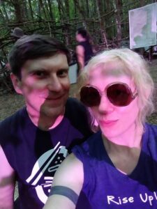 Walt Courtney standing with a woman in sunglasses who is taking a selfie with him.