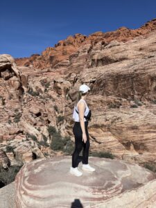 Sarah Cave looking over a rocky canyon landscape.