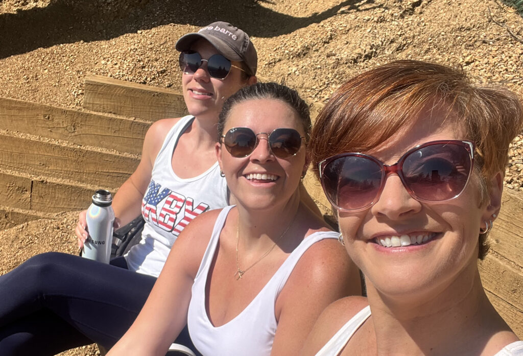 Laura Johnson, Diana Harris and Andrea Pineiro sitting on the top of the steps of Manitou Incline.