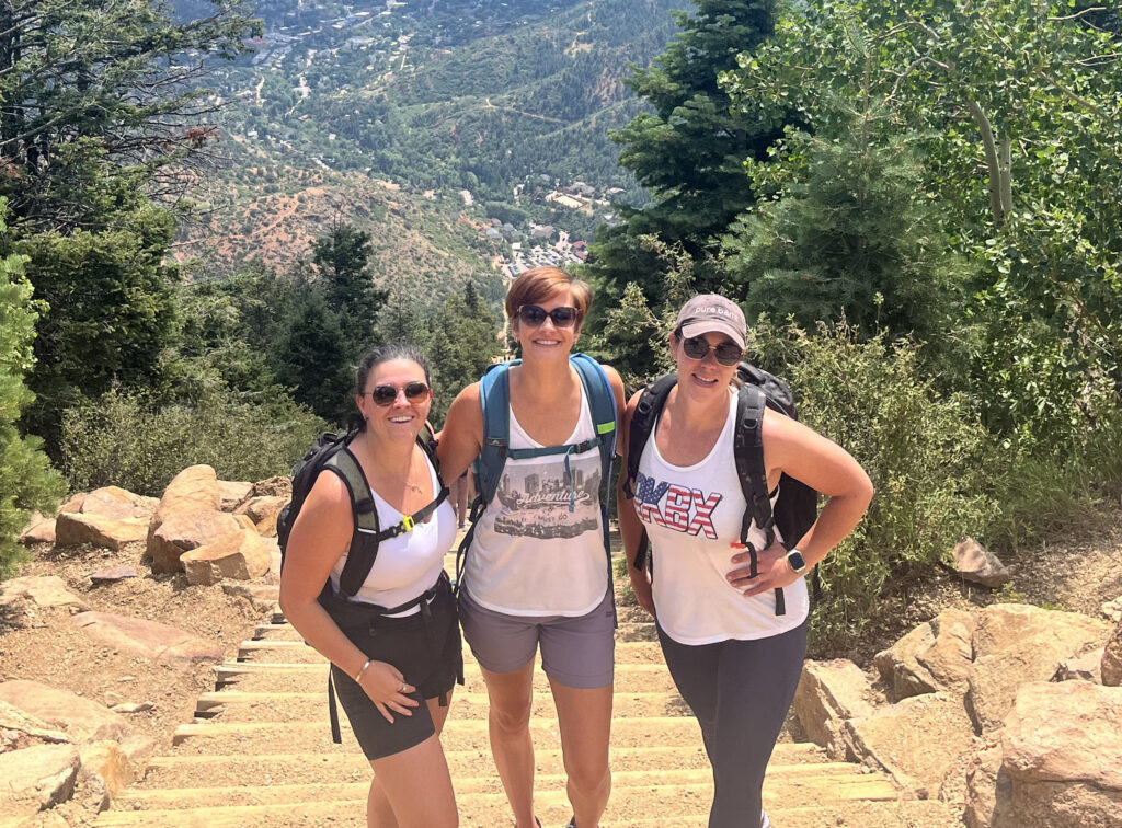 Laura Johnson, Diana Harris and Andrea Pineiro standing at the top of the stairs of the Manitou Incline.