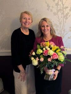 Sheri Butler and Lori Kress standing and smiling for photo.