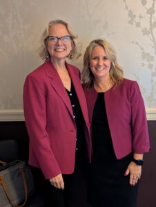 Karin Stockwell stand together and smile for the picture.