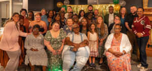 Large group of people posing for photo.