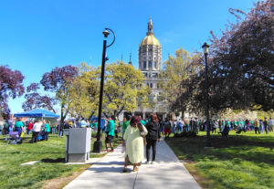 Crowds of people walking toward the Connecticut State Capitol.