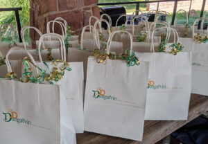 Gift bags lined up on a table.