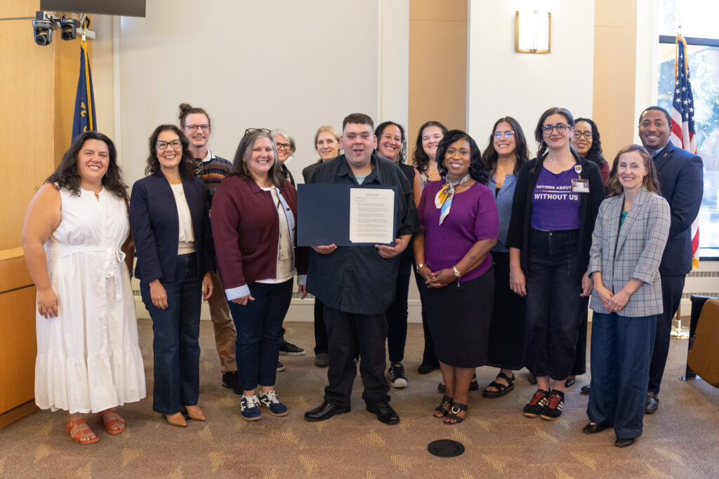 Group shot of Multnomah County OR, leaders standing in a county government building.